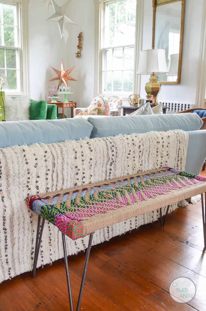 White bright living room with colorful decor and eclectic design.