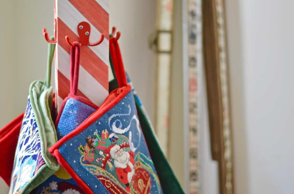 DIY striped lattice holiday stocking post- adorable way to display your stockings this season!