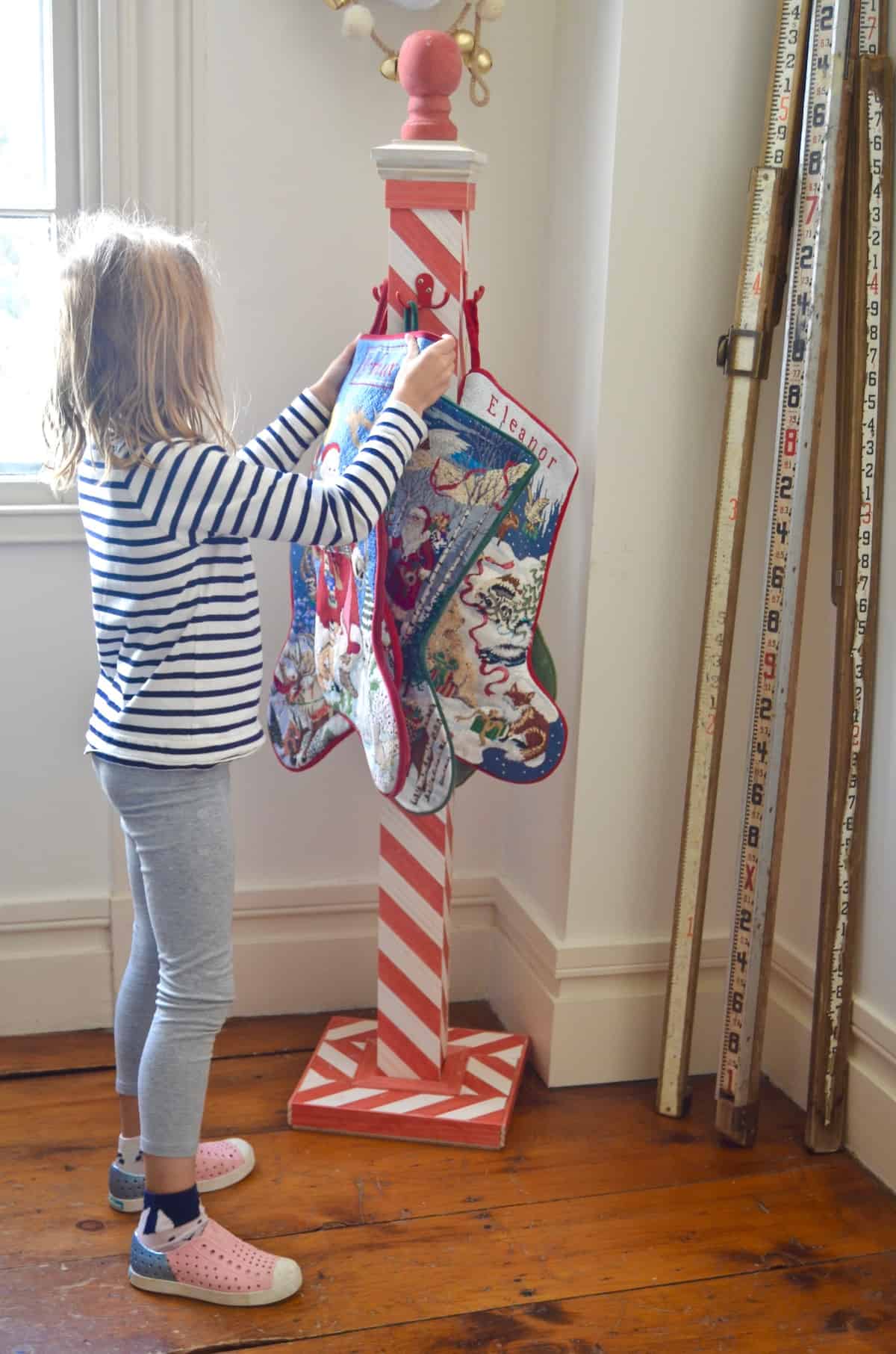 DIY striped lattice holiday stocking post- adorable way to display your stockings this season!