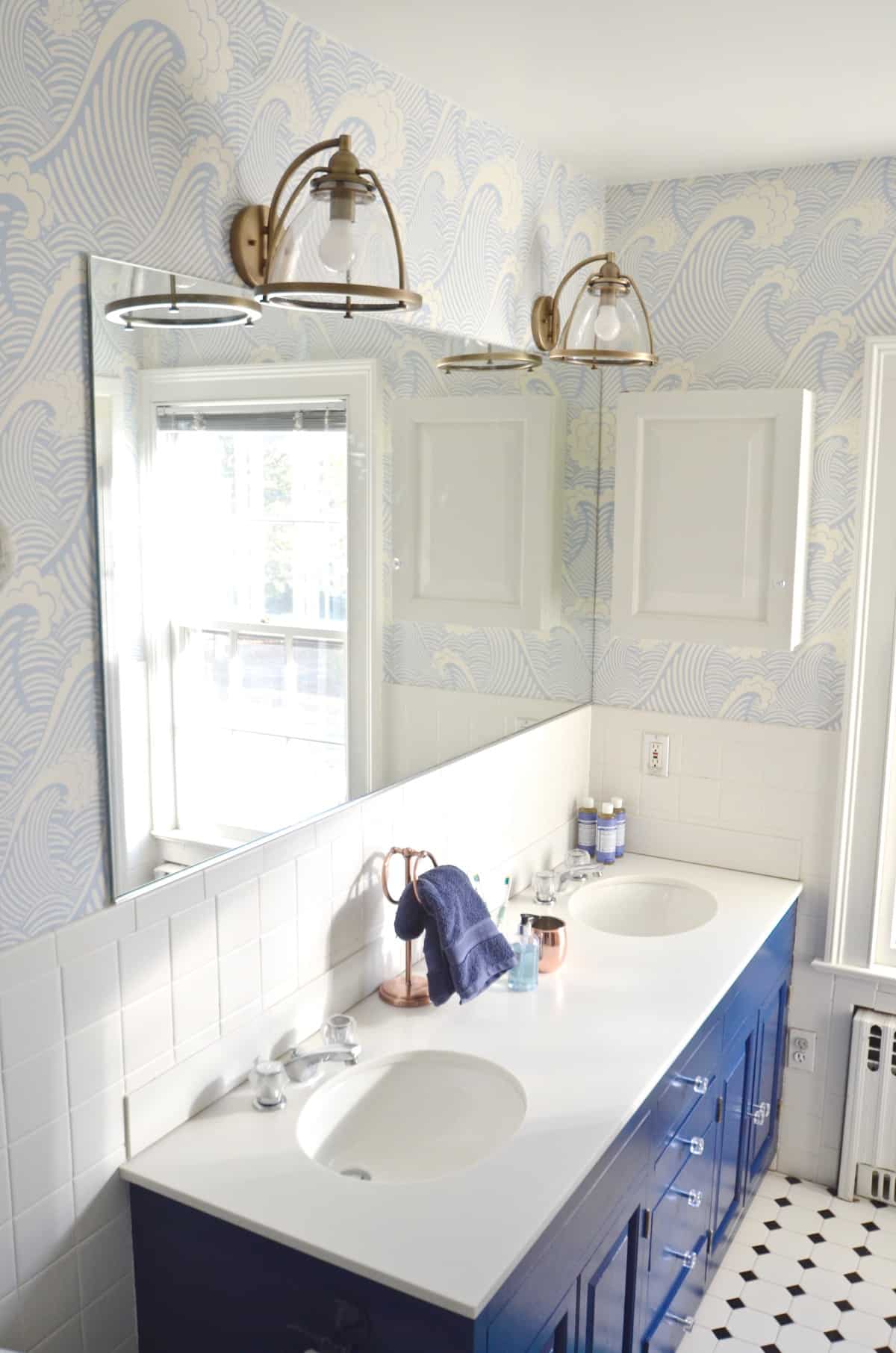 Updated kids bathroom with wallpaper and new pendant lights.