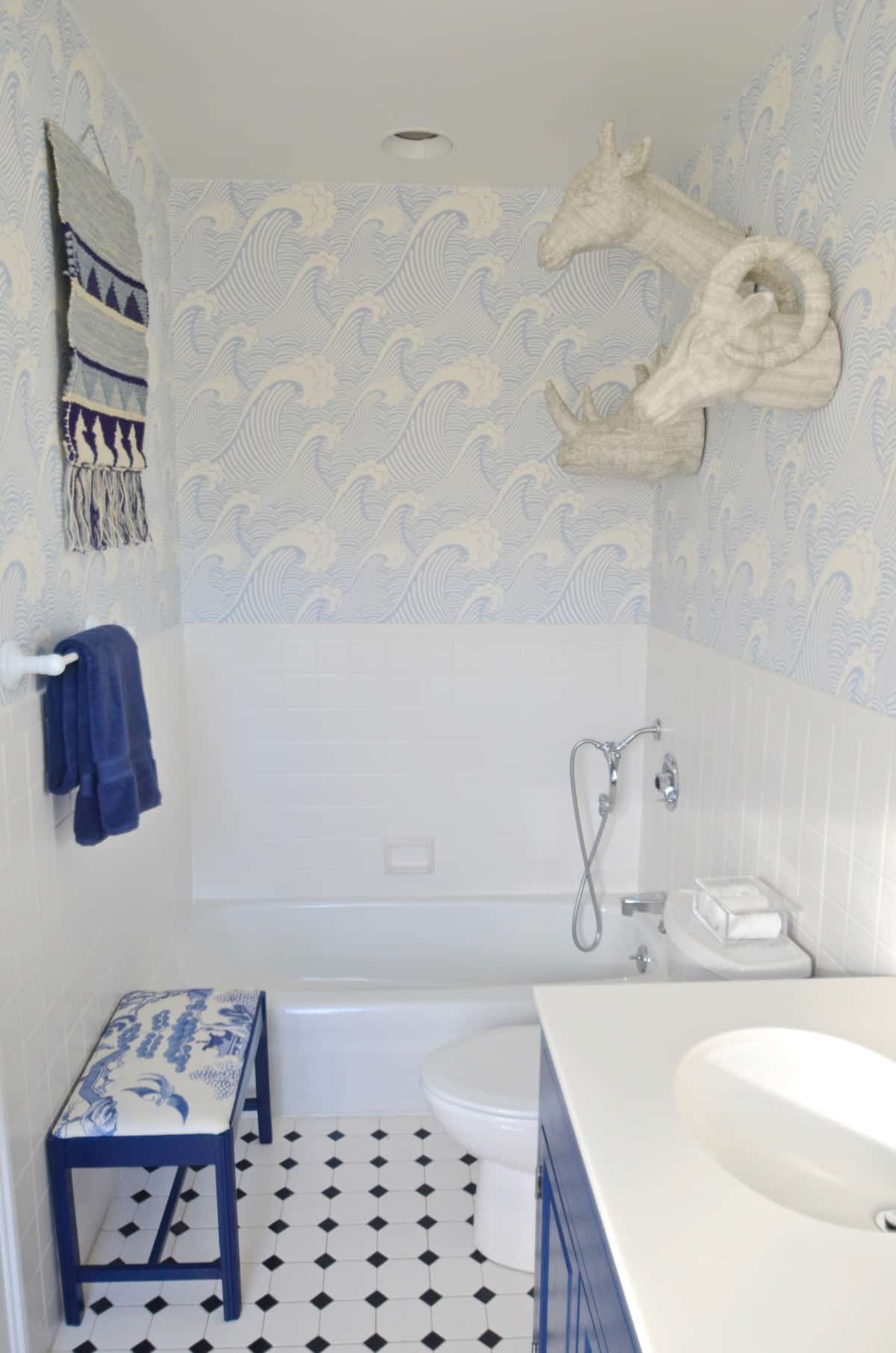 Updated kids bathroom with wallpaper and new pendant lights.