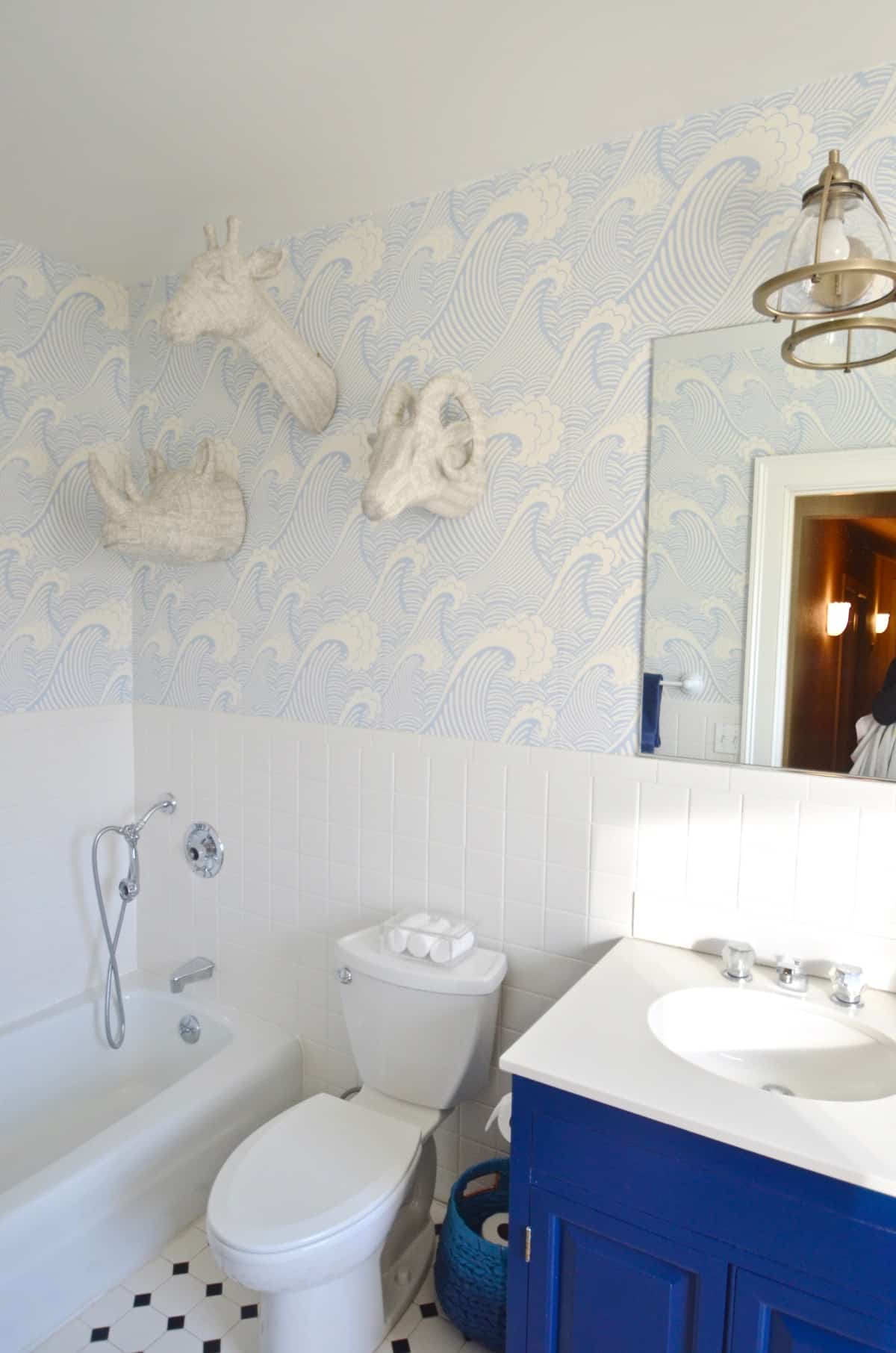 Updated kids bathroom with wallpaper and new pendant lights.