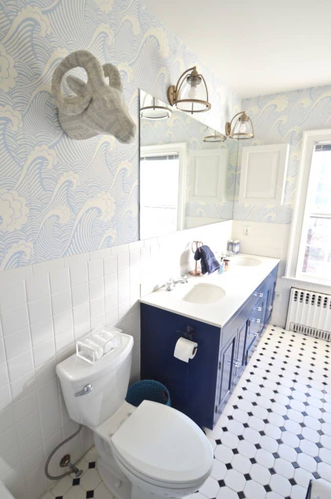 Updated kids bathroom with wallpaper and new pendant lights.