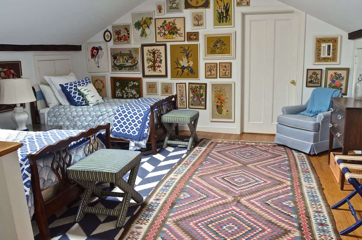 Updated guest room with new upholstered headboards and a repainted rich vintage gallery wall.