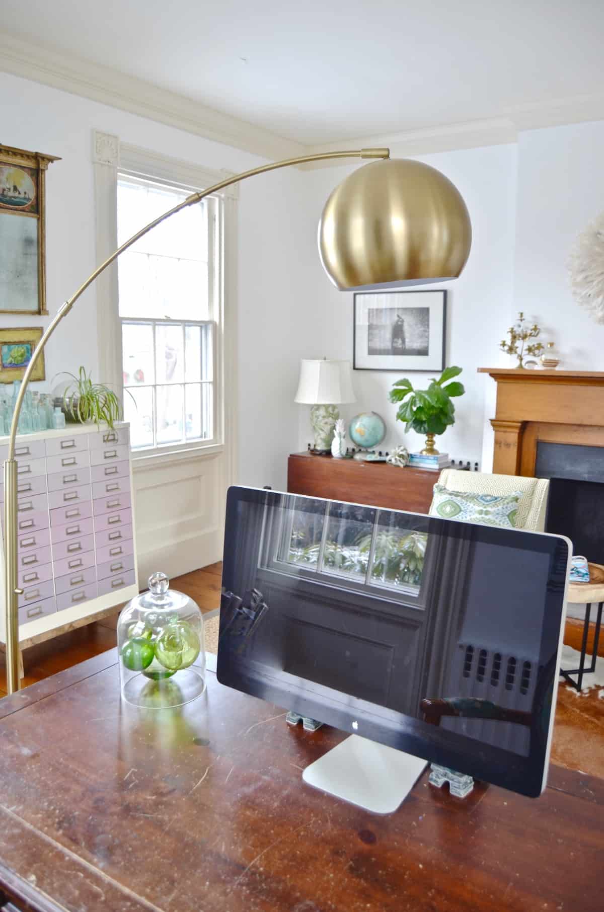 Colorful and bright office decorated with seating area and eclectic accessories.