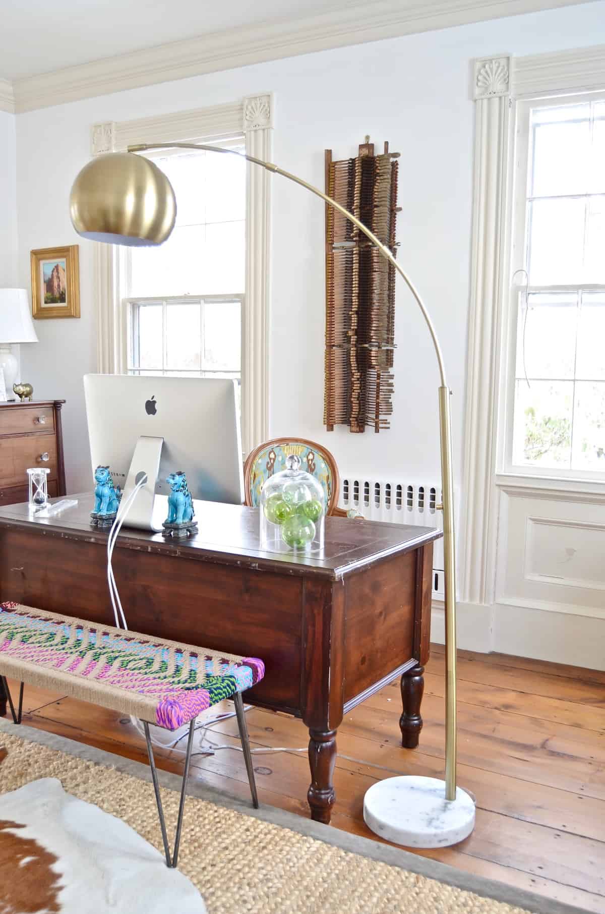 Colorful and bright office decorated with seating area and eclectic accessories.