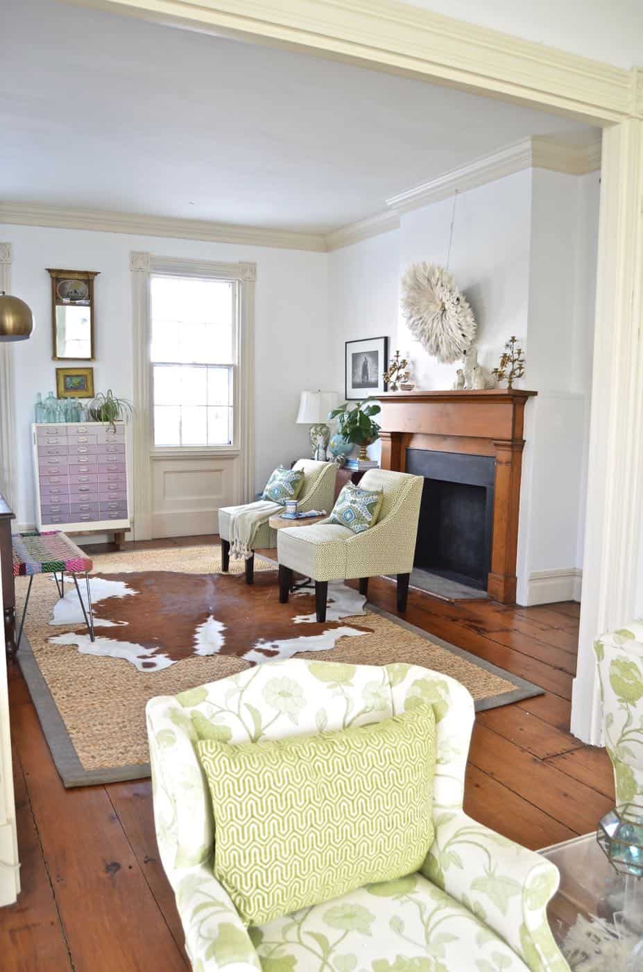 Colorful and bright office decorated with seating area and eclectic accessories.