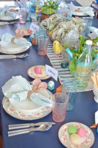 Lush coral and blue eclectic easter tablescape.