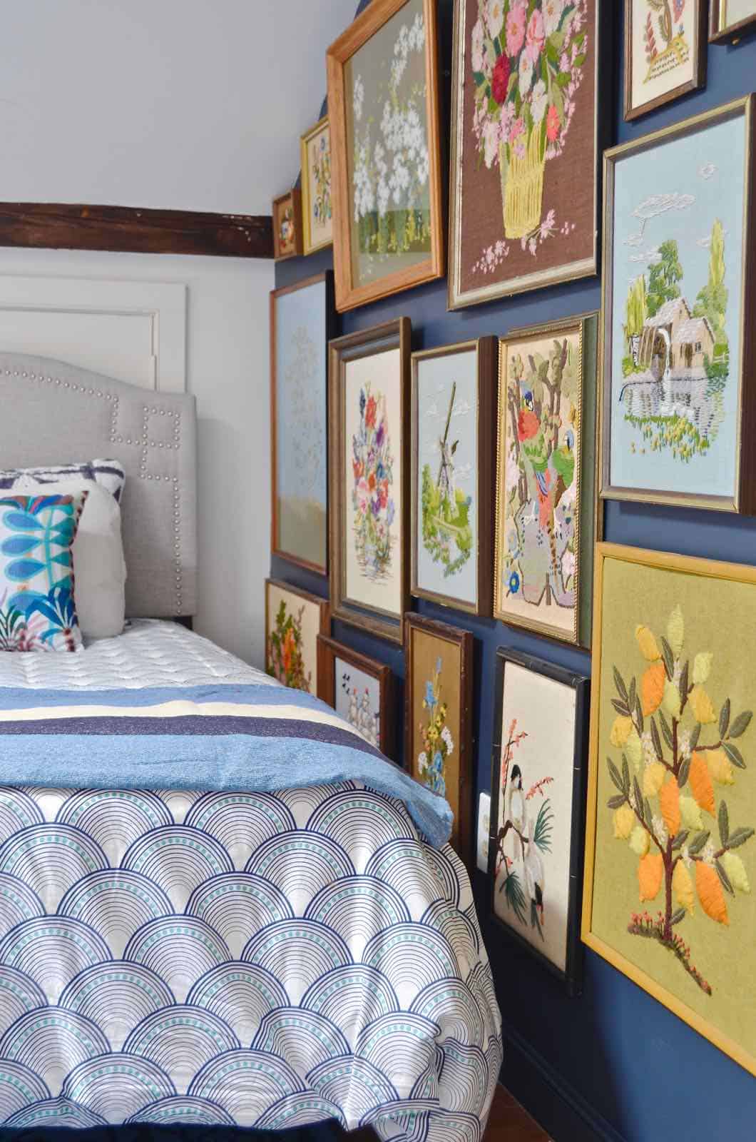 Updated guest room with new upholstered headboards and a repainted rich vintage gallery wall.