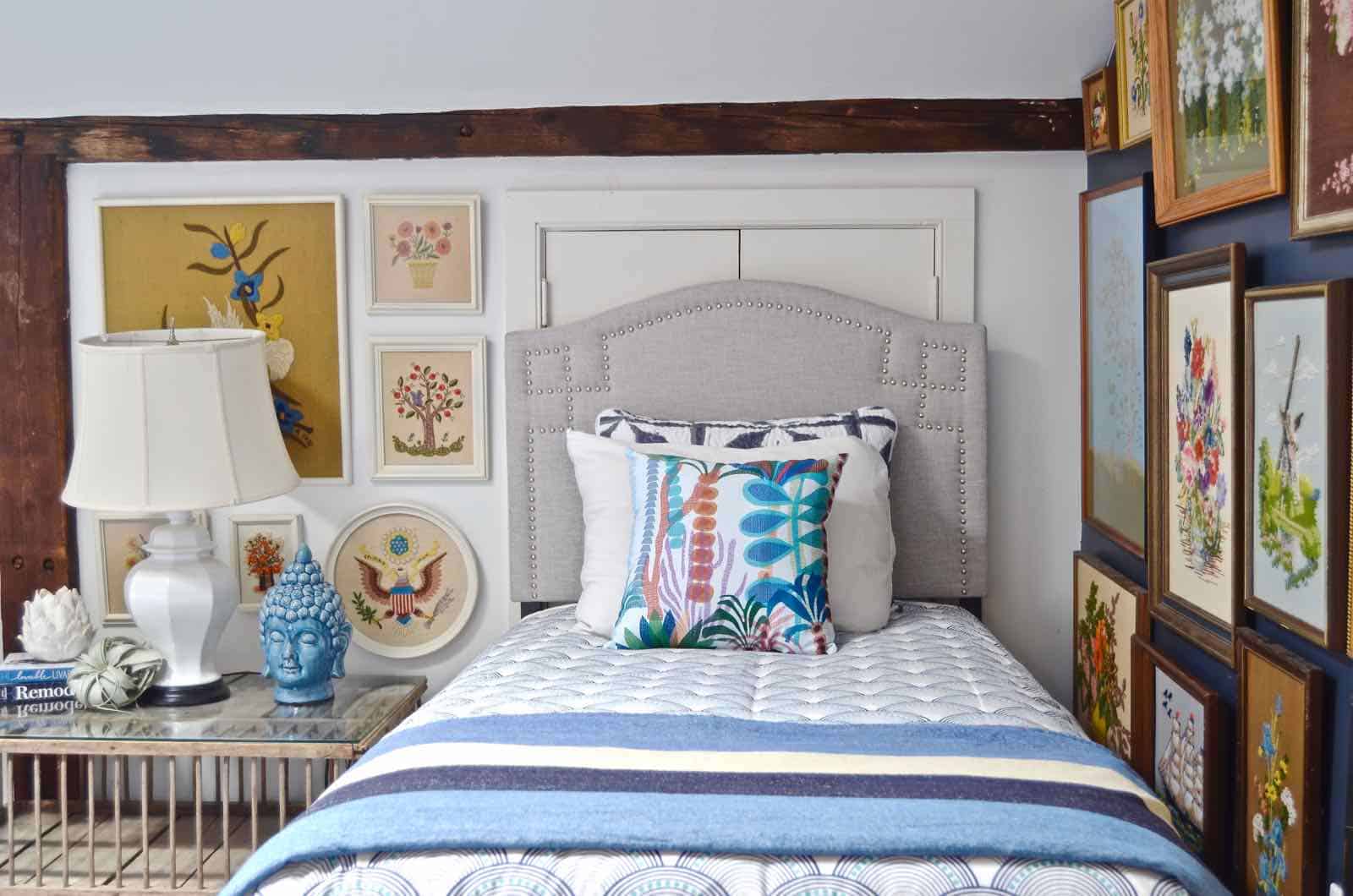 Updated guest room with new upholstered headboards and a repainted rich vintage gallery wall.