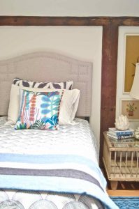 Updated guest room with new upholstered headboards and a repainted rich vintage gallery wall.