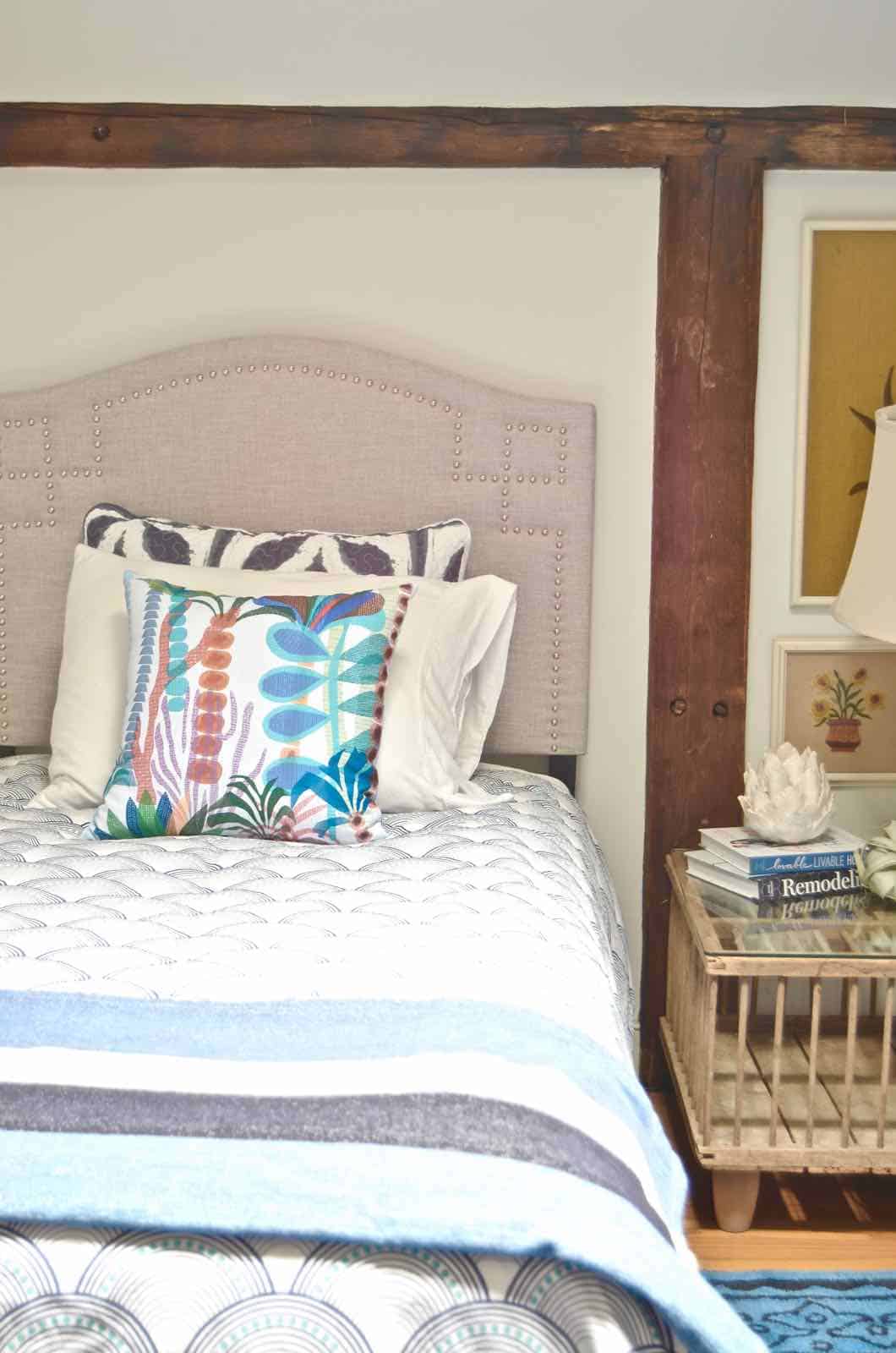 Updated guest room with new upholstered headboards and a repainted rich vintage gallery wall.