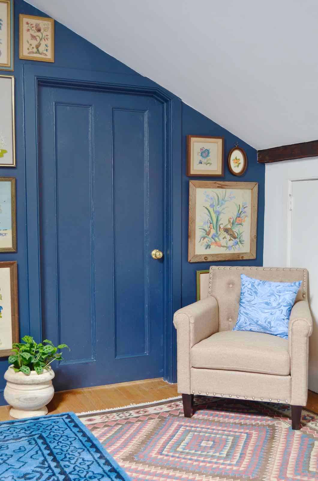 Updated guest room with new upholstered headboards and a repainted rich vintage gallery wall.