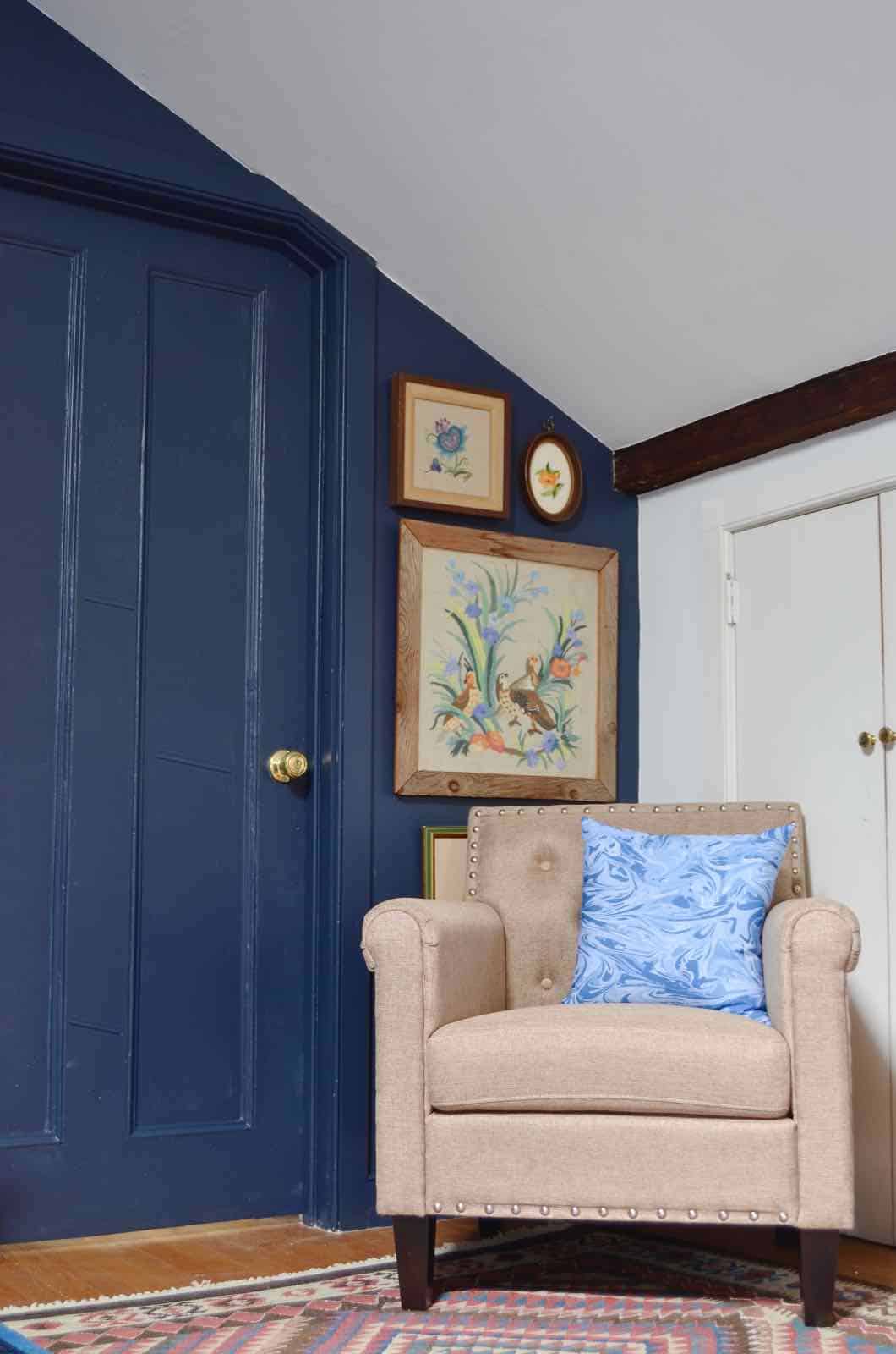 Updated guest room with new upholstered headboards and a repainted rich vintage gallery wall.