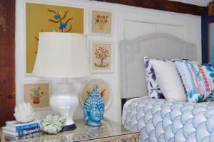 Updated guest room with new upholstered headboards and a repainted rich vintage gallery wall.