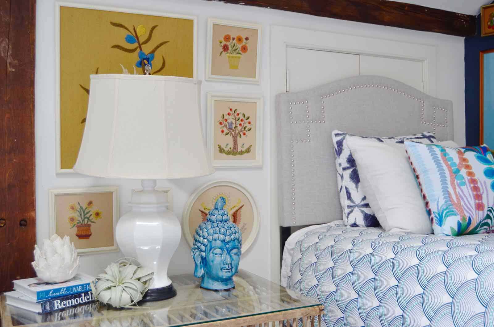 Updated guest room with new upholstered headboards and a repainted rich vintage gallery wall.