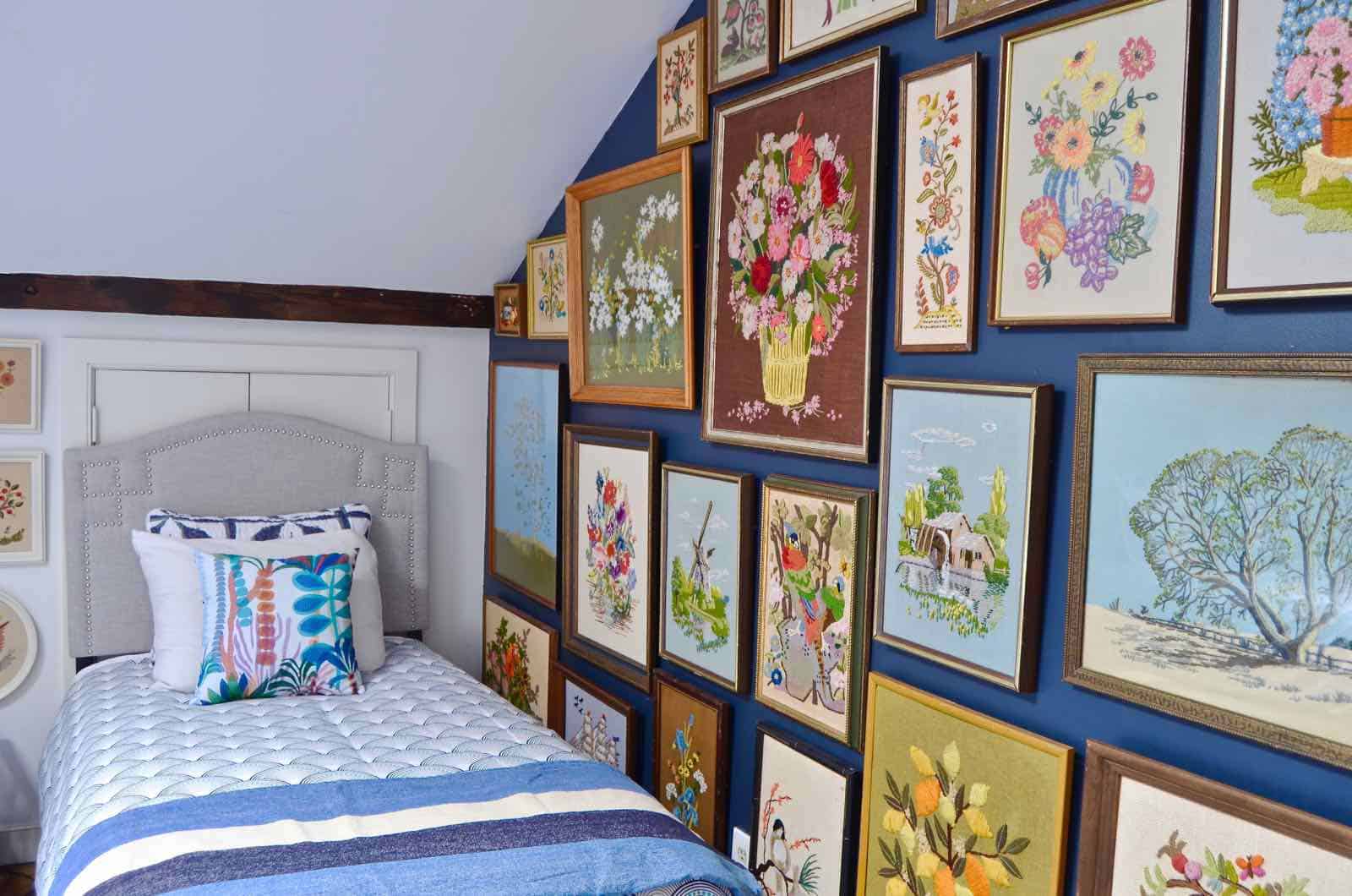 Updated guest room with new upholstered headboards and a repainted rich vintage gallery wall.