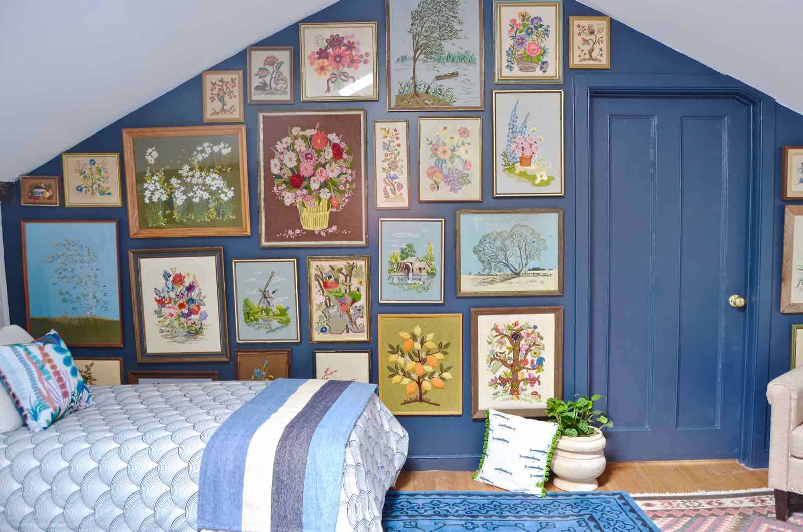 Updated guest room with new upholstered headboards and a repainted rich vintage gallery wall.