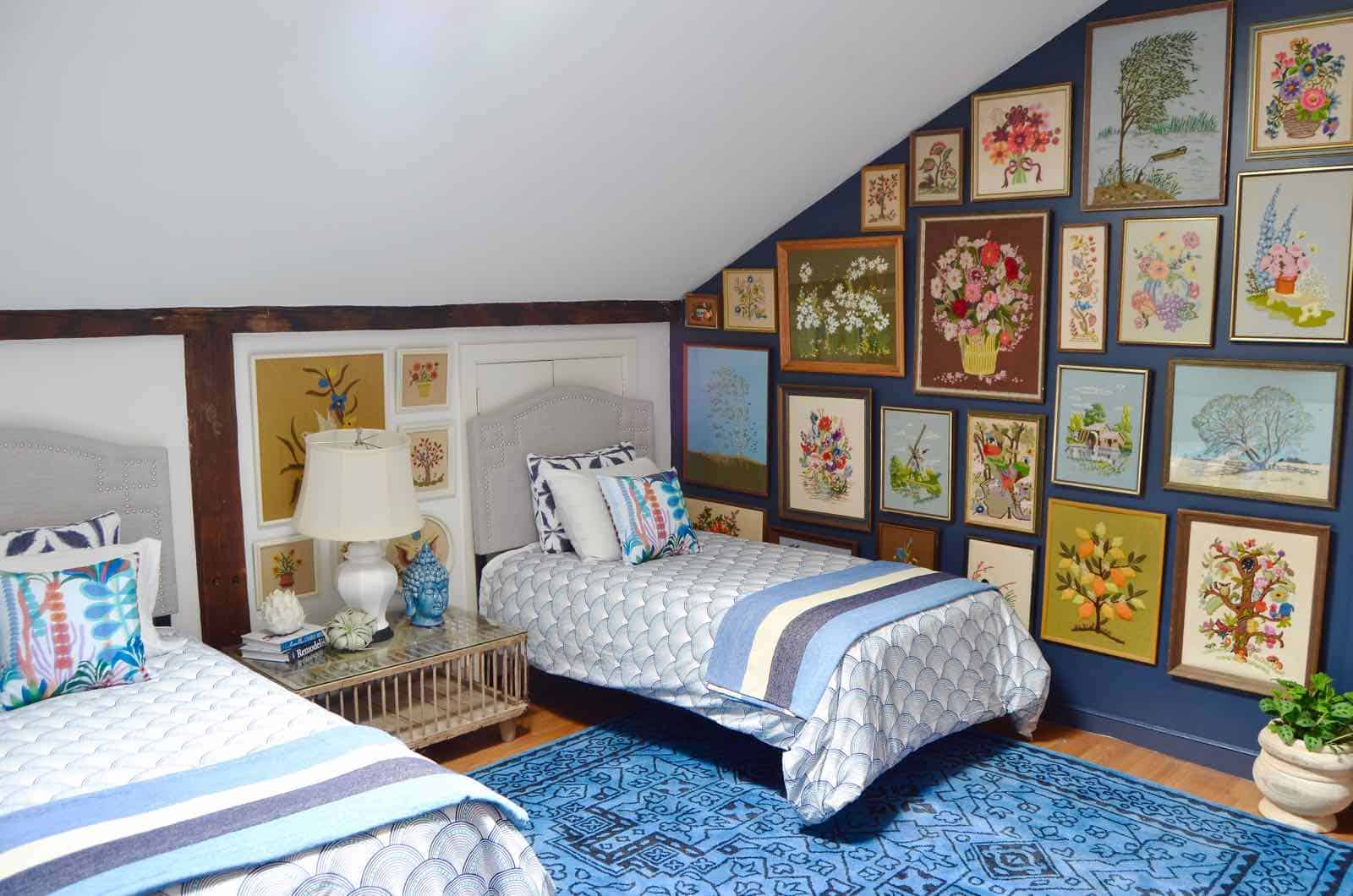 Updated guest room with new upholstered headboards and a repainted rich vintage gallery wall.