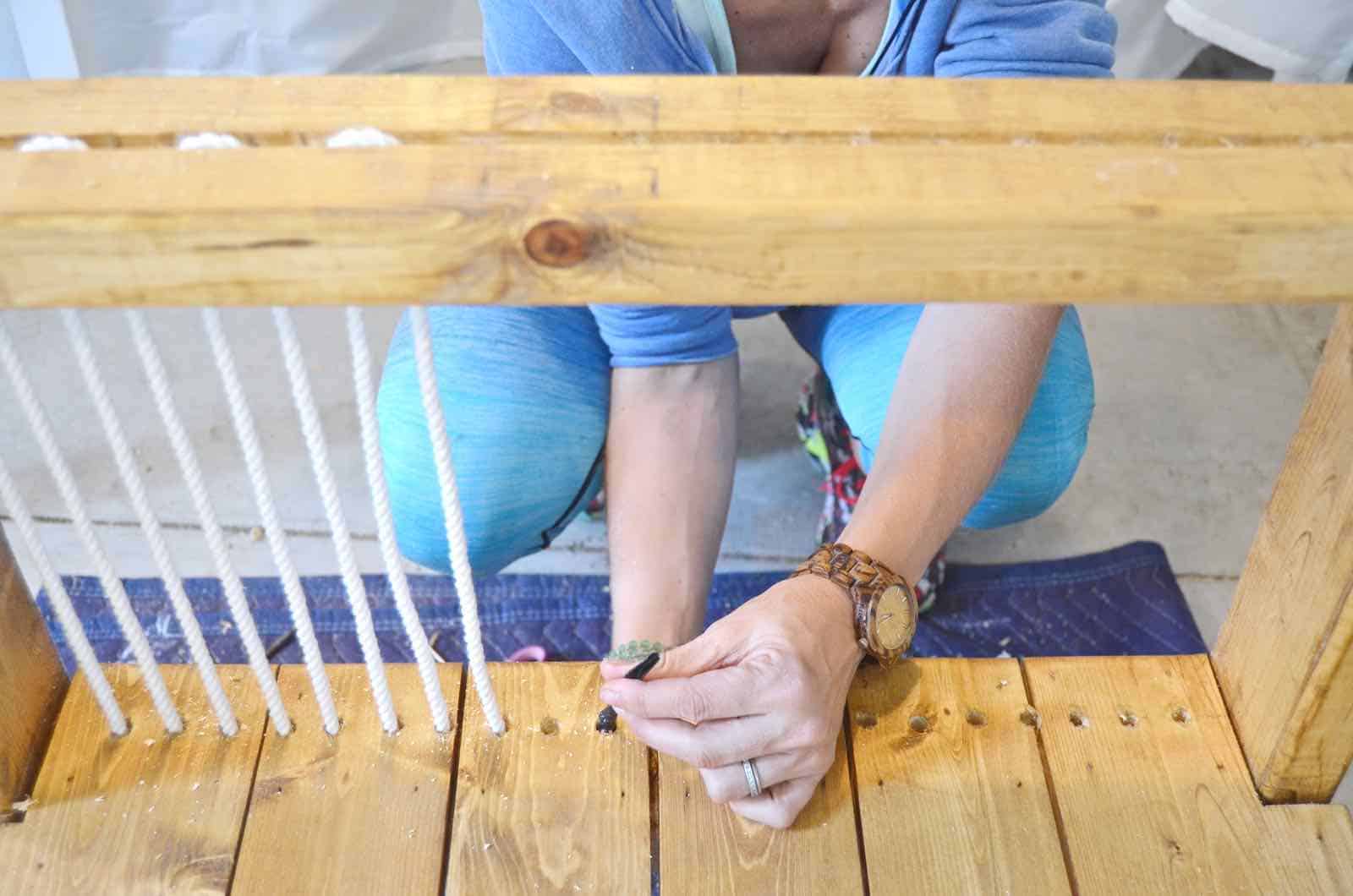 DIY bench made out of 2x4s with chic rope detail