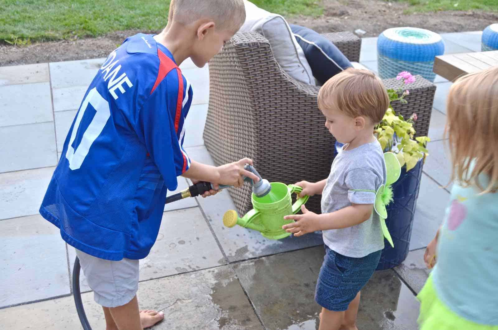 filling water cans with spray attachment