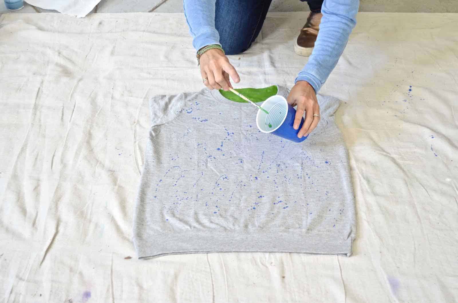 splatter painting a sweatshirt