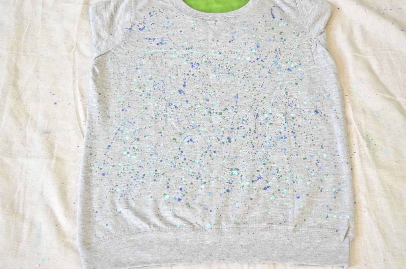 splatter painting a sweatshirt