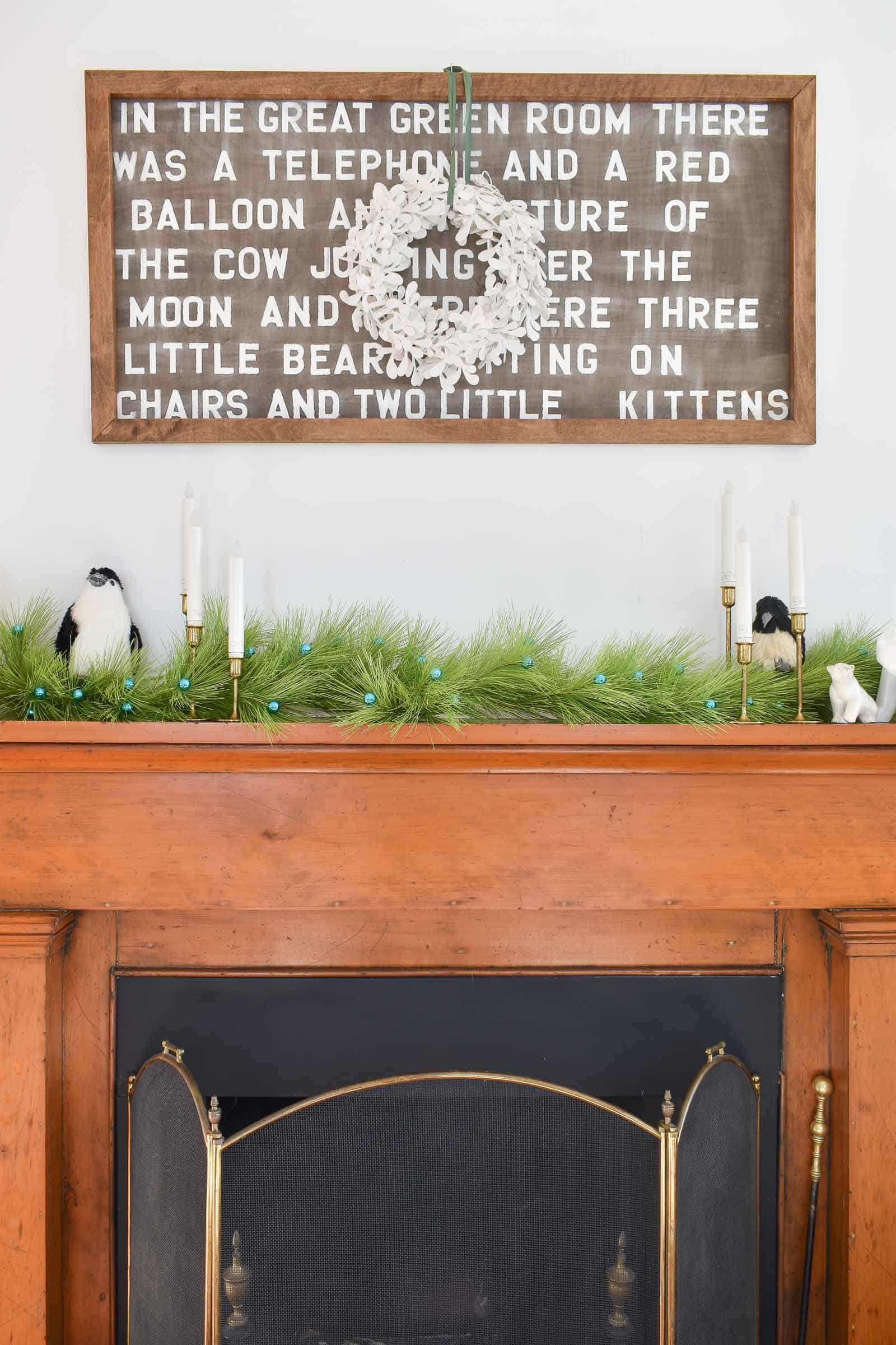 holiday mantle with greenery and critters