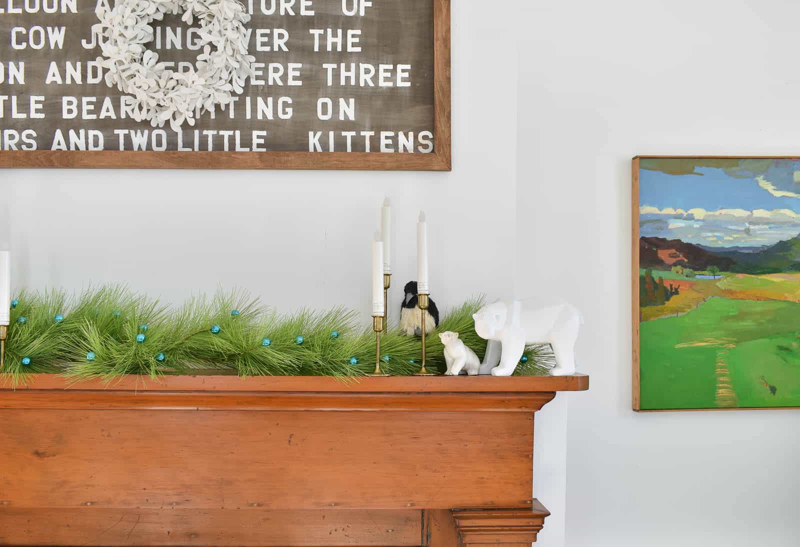 holiday mantle with greenery and critters