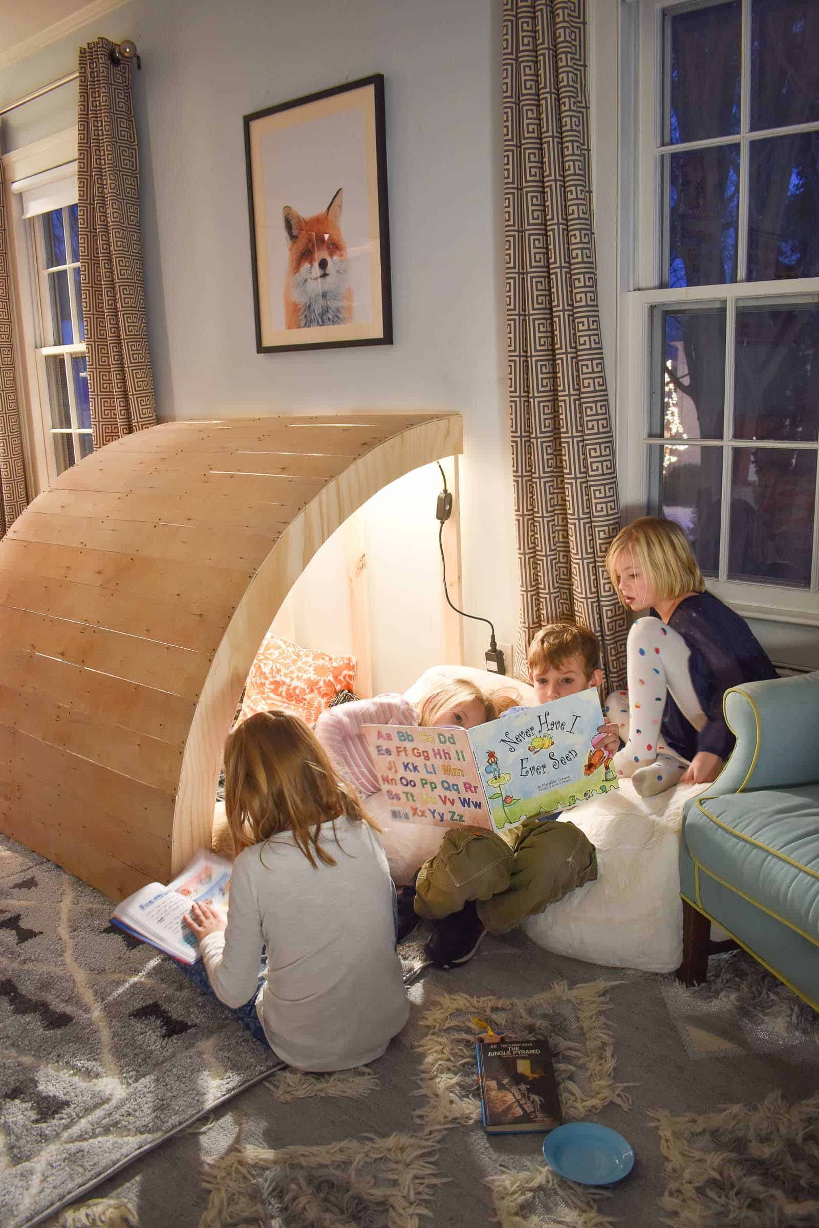 children sitting in reading nook