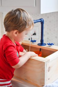 Arthur standing at toy sink
