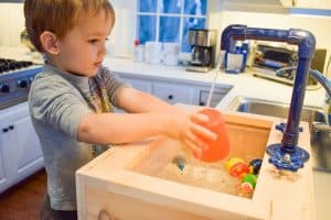 playing with toy sink