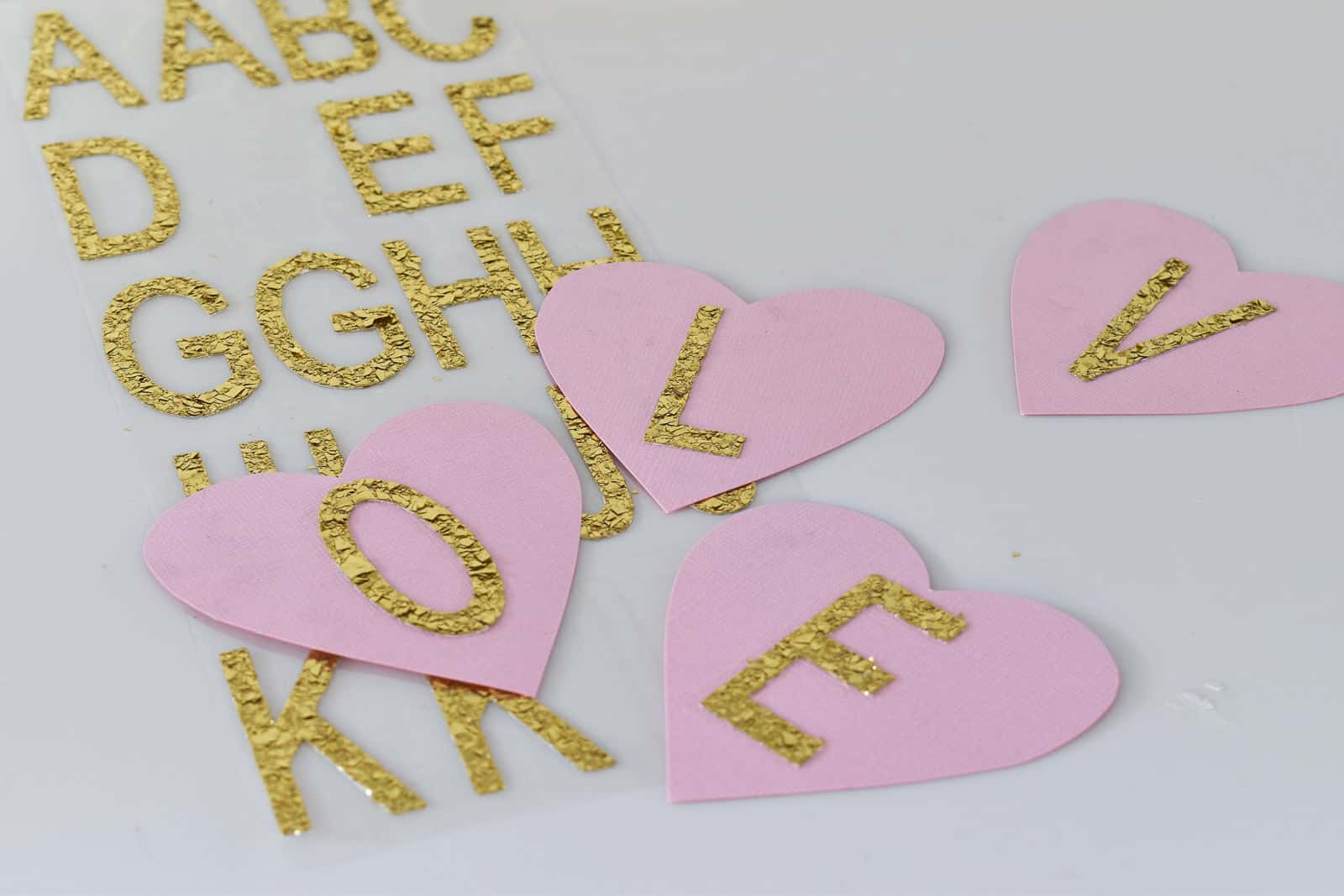 place stickers onto paper hearts