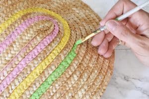 painting the straw clutch with rainbow colors