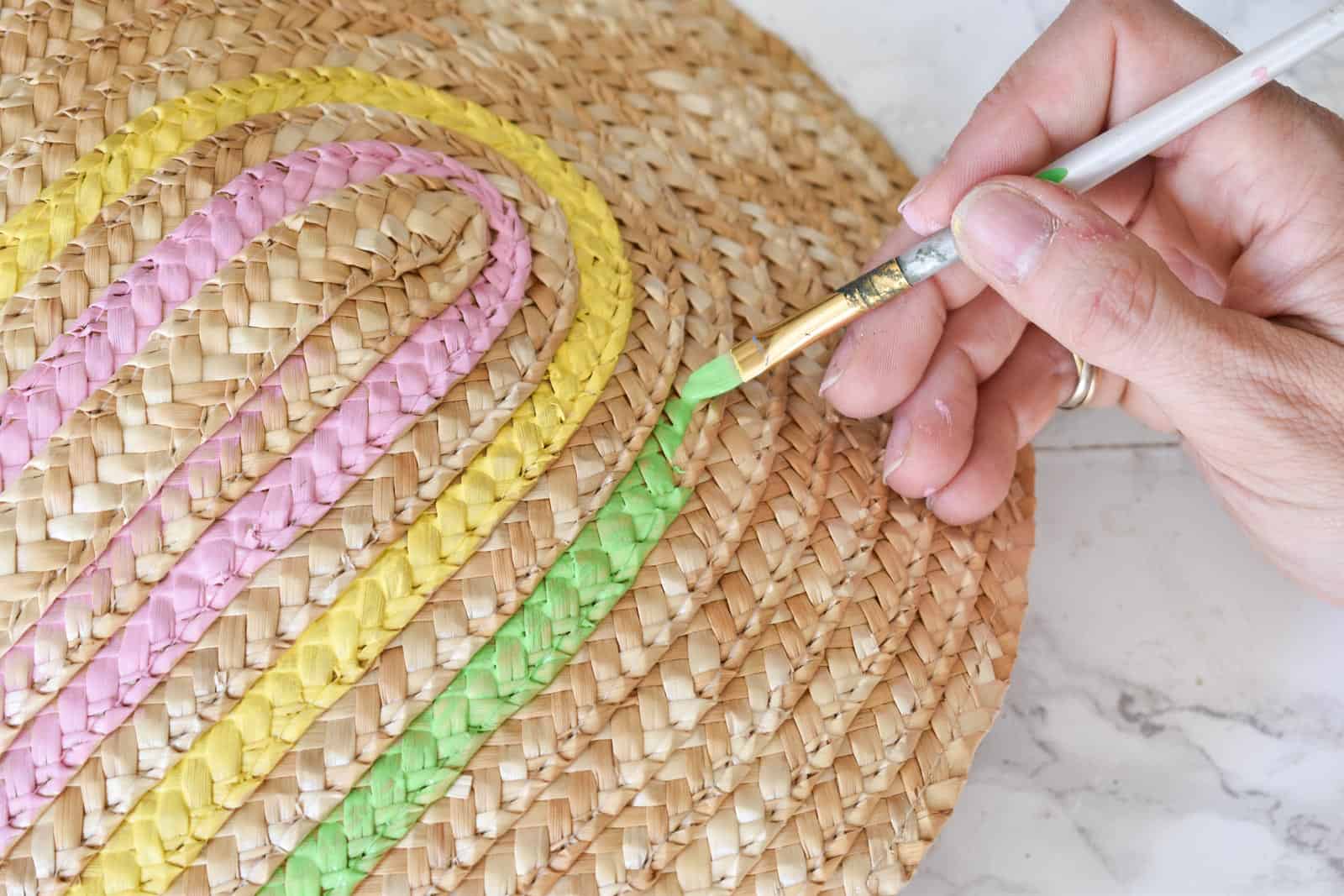 painting the straw clutch with rainbow colors