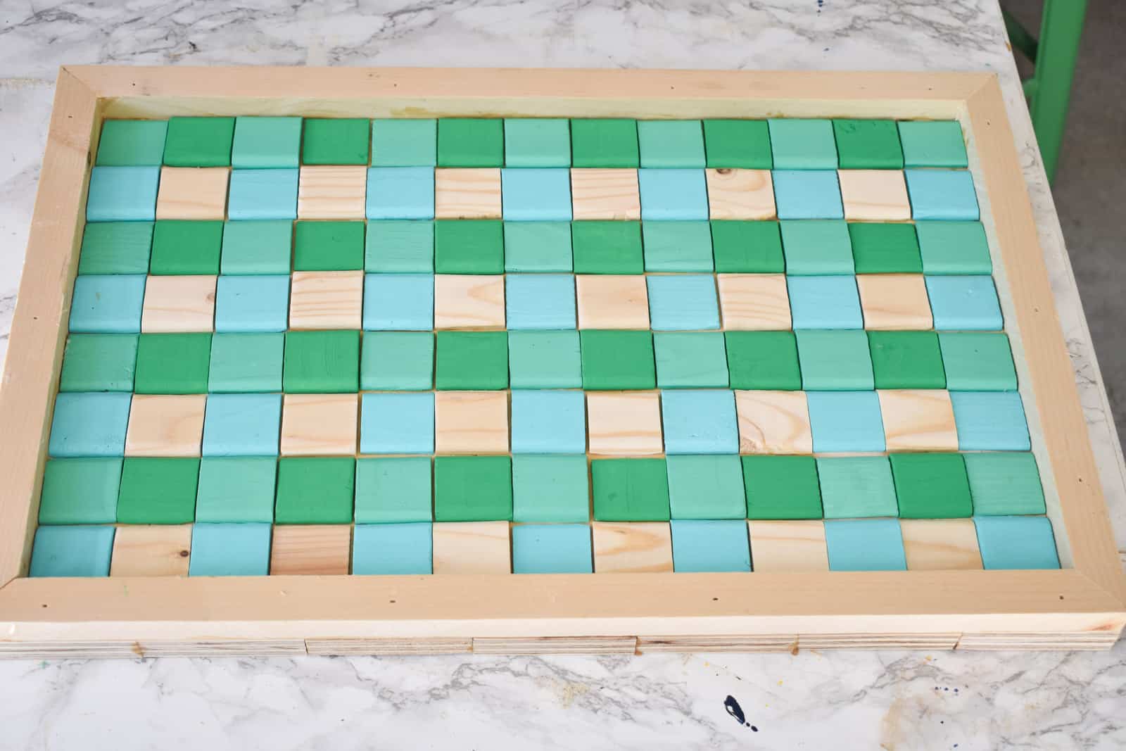 Glue the squares onto tray