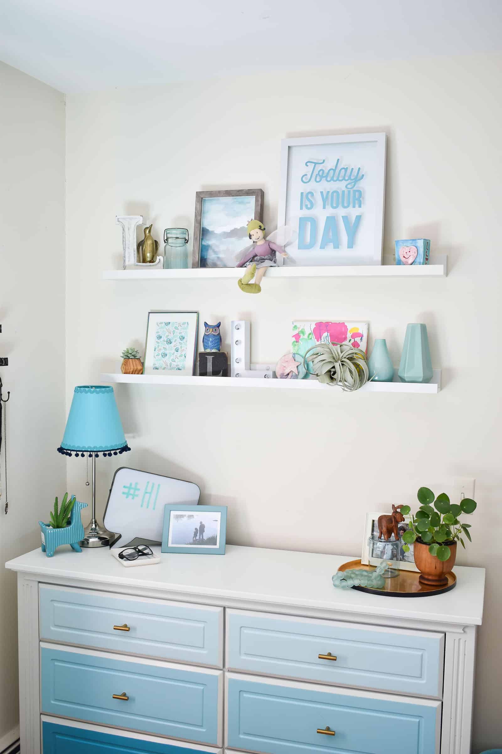 dresser wall with floating shelves in girls bedroom