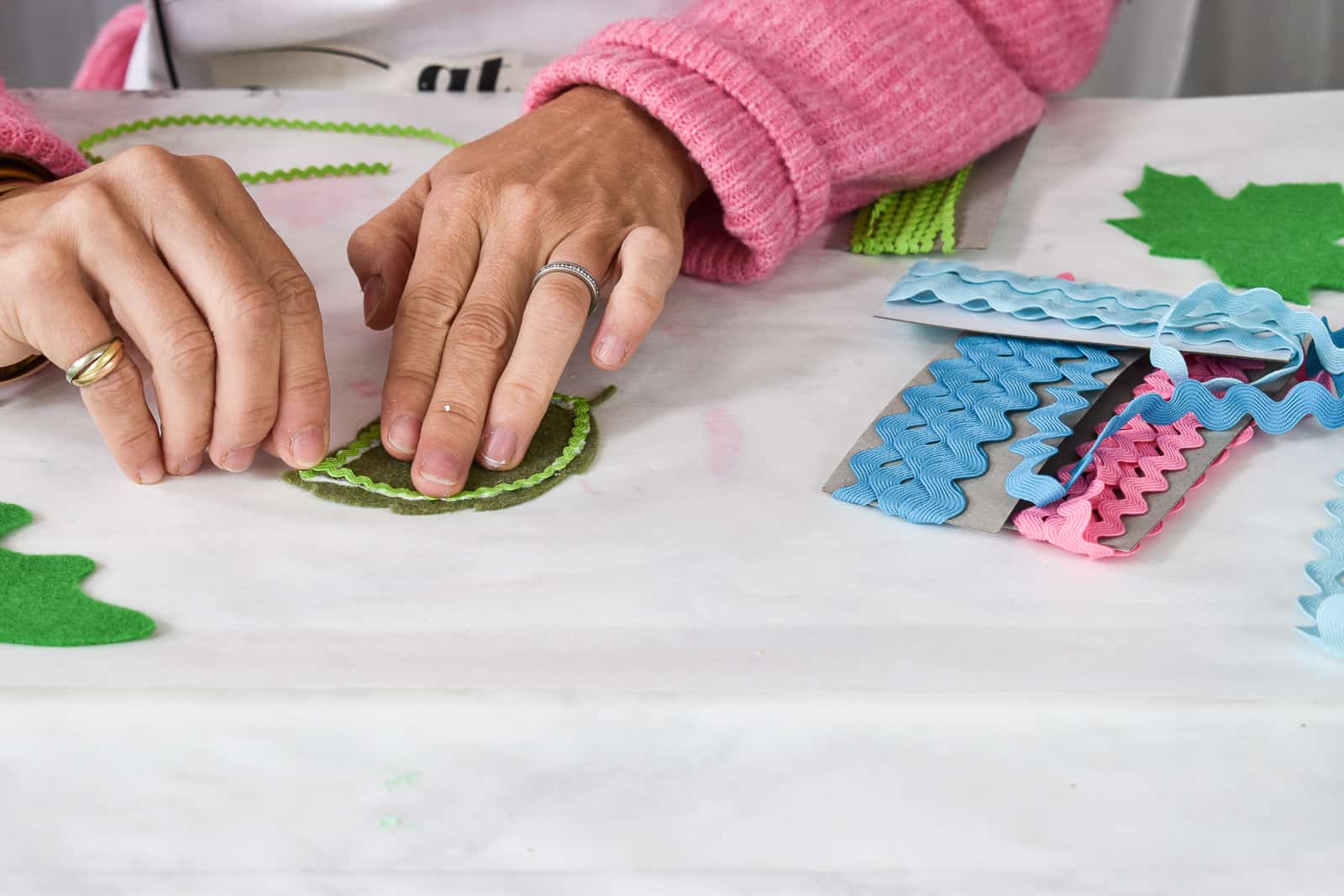 gluing rick rack onto felt leaves