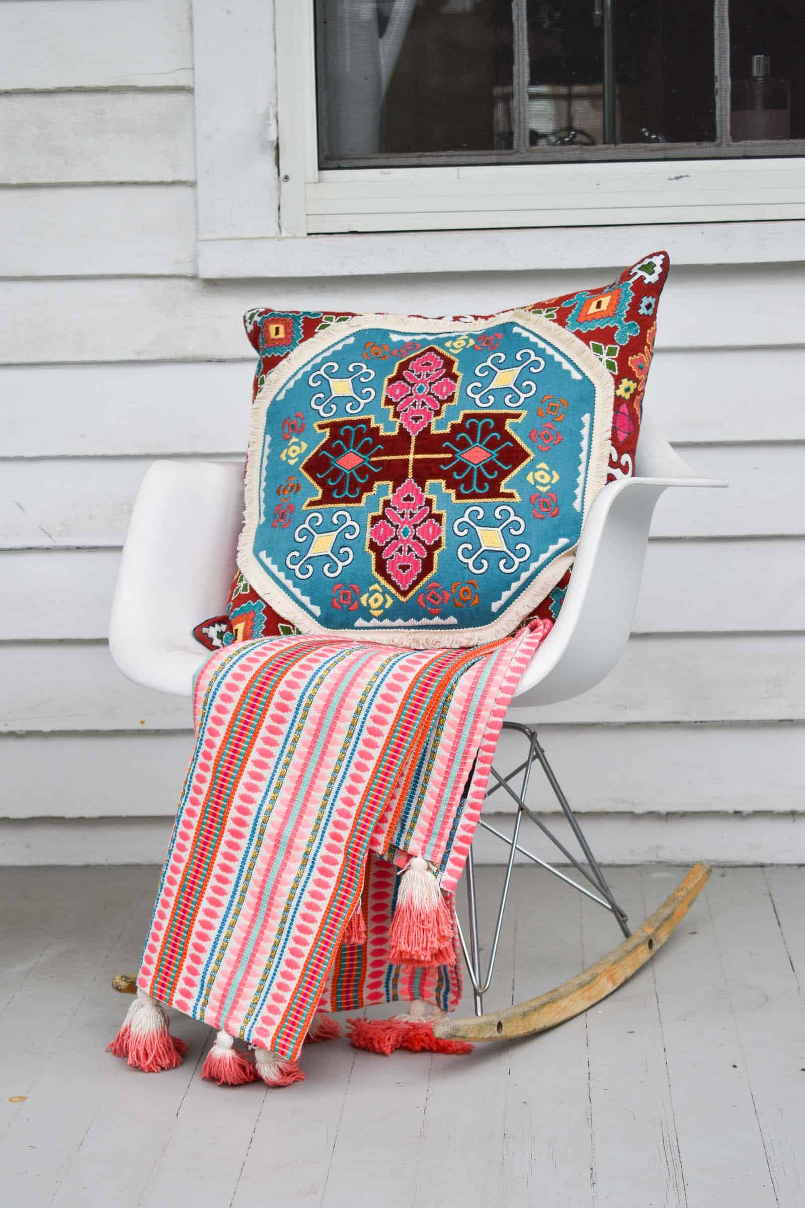 bright pillow on white chair