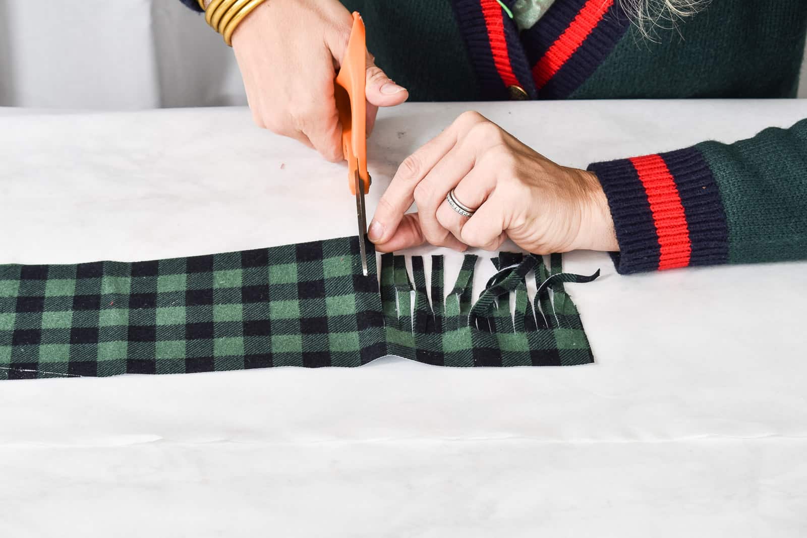 cut the fringe into the plaid fabric