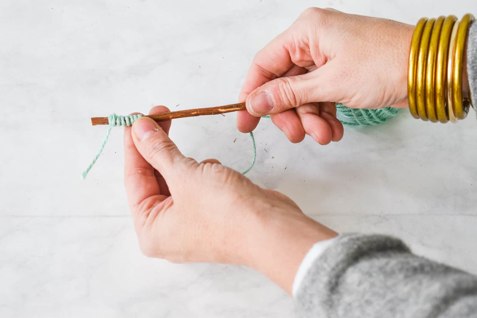 wrap the twine by twisting with one hand