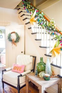 staircase with colorful garland and greenery
