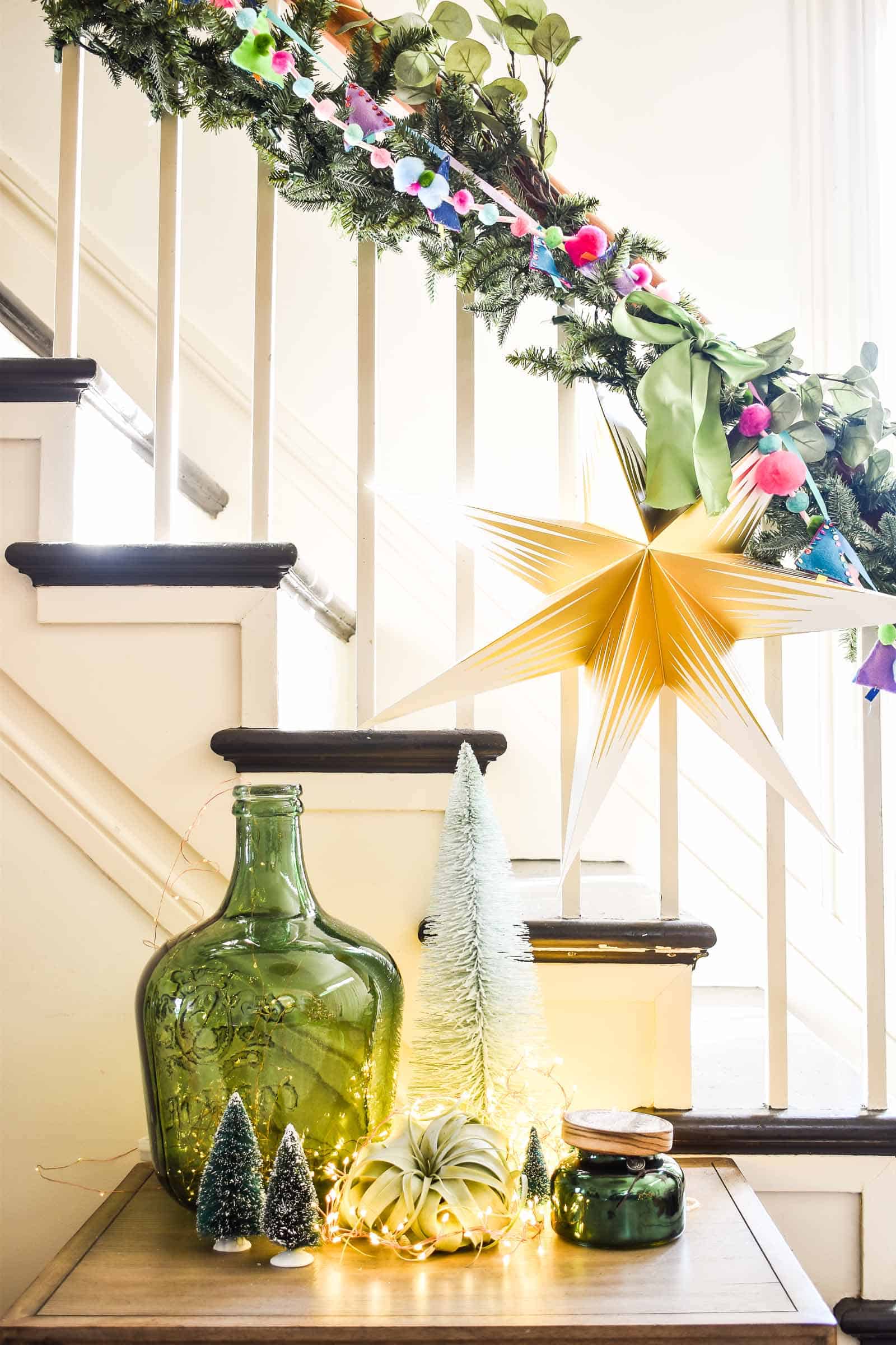 staircase with colorful garland and greenery