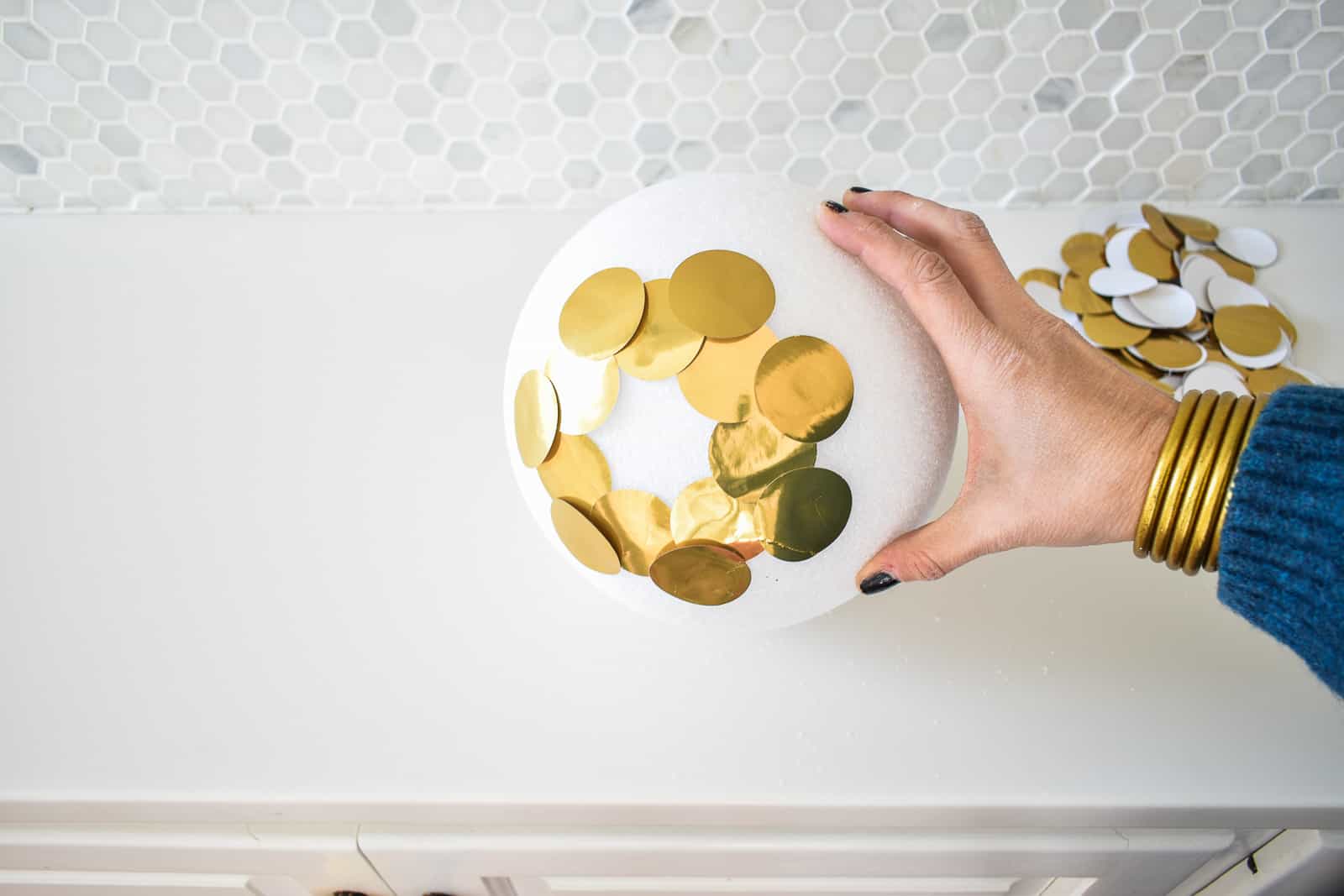 glue gold circles onto foam ball