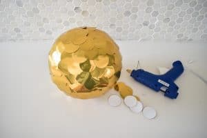 glue gold circles onto foam ball