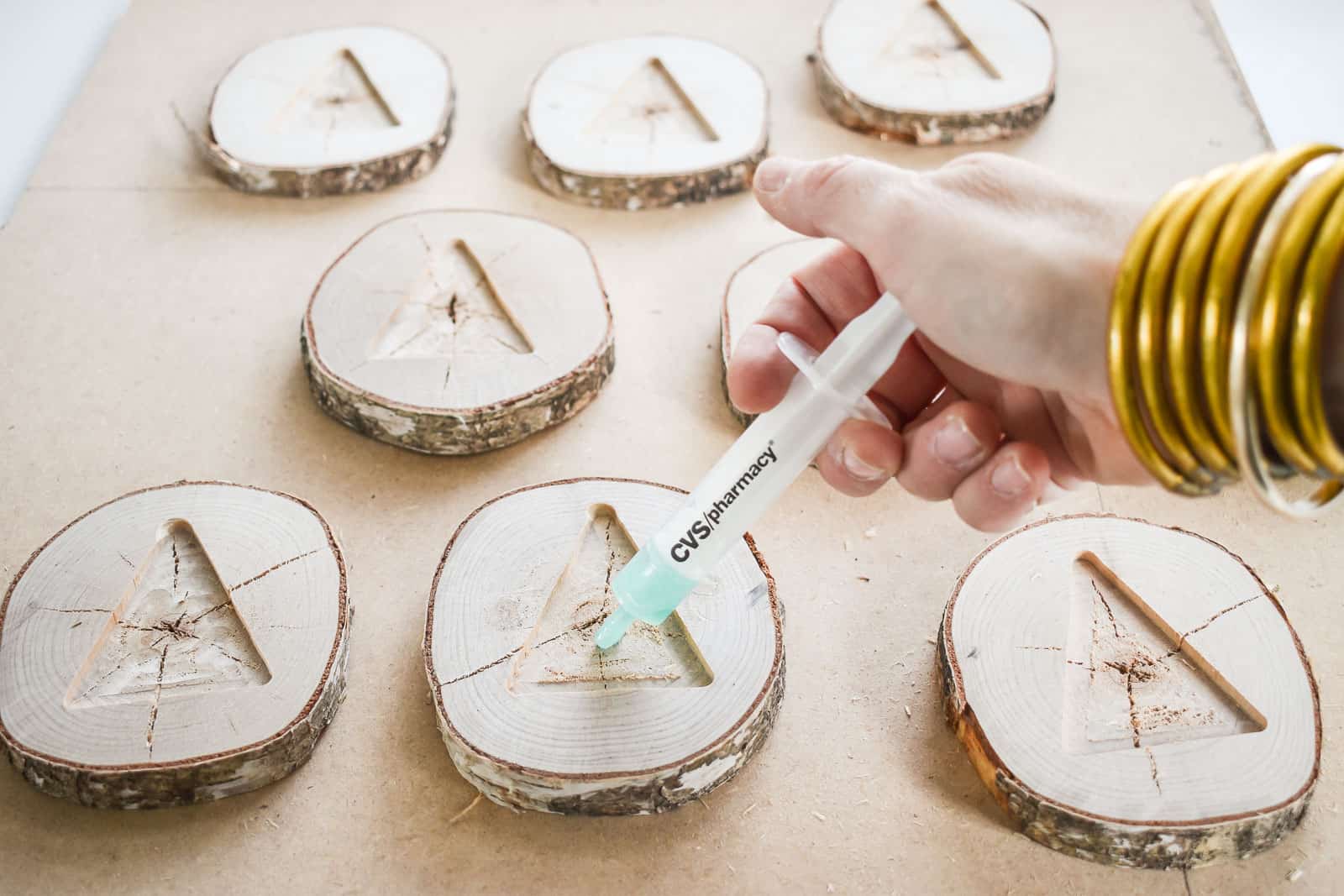 using a syringe to control the resin pour into the wood slices