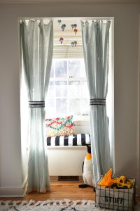 adding curtains to make a window seat reading nook