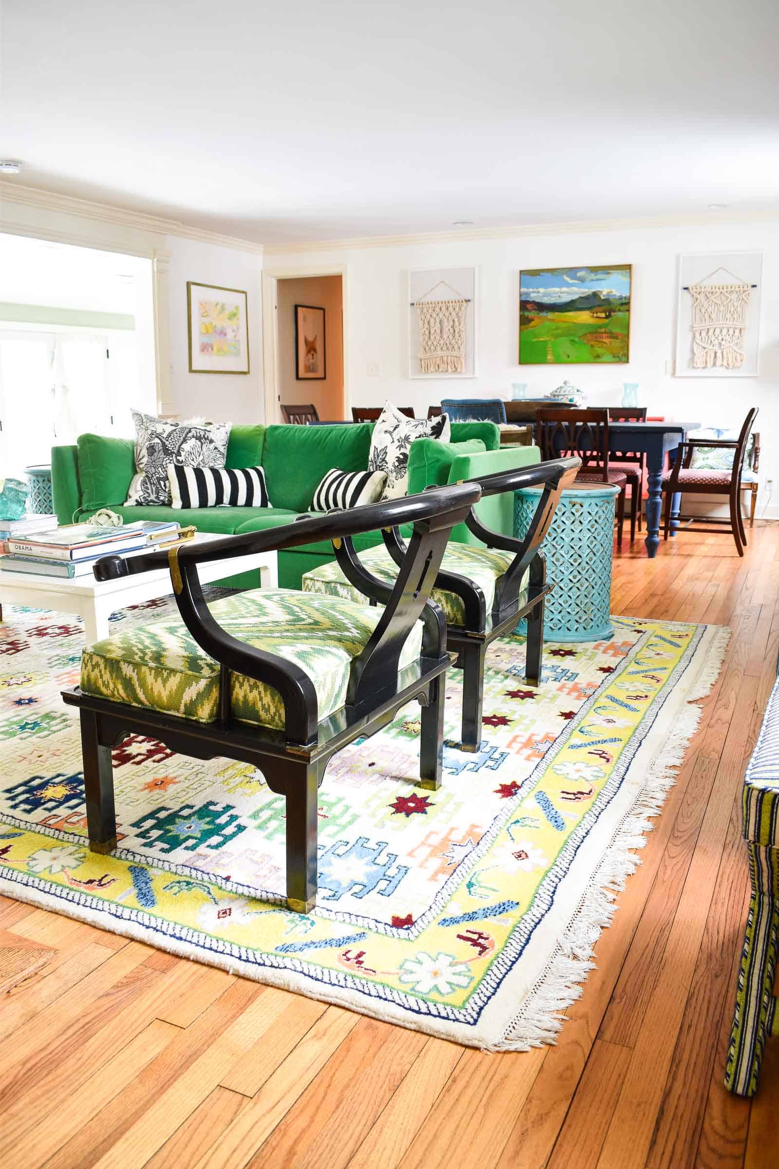 pair of flea market black chairs in colorful living room