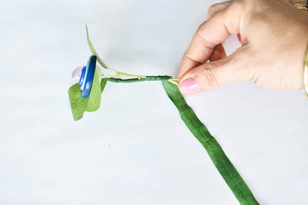 wrap faux leaves into the button flower stems