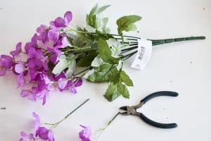 use wire cutter to cut flowers from arrangement